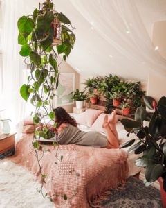 Boho bedroom with plants and wall decor