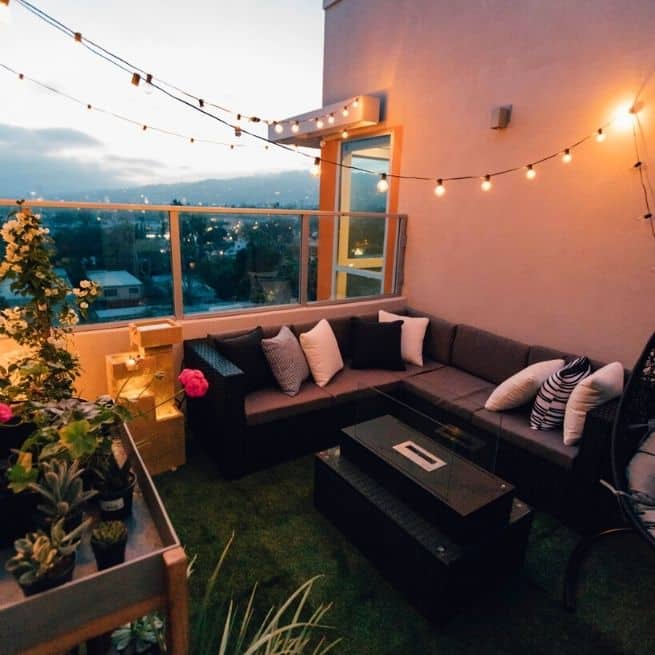 balcony decor with string lights and a privacy wall