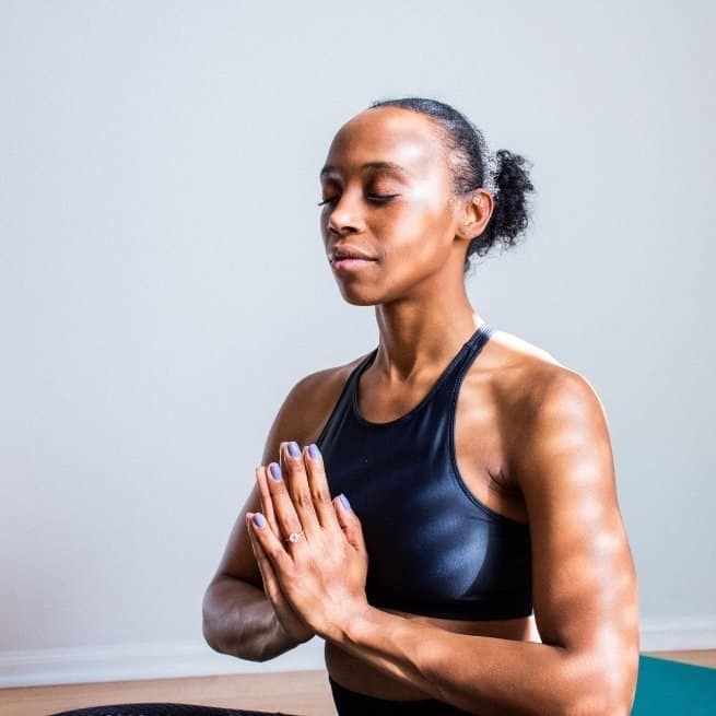 women doing yoga mindfully with eyes closed