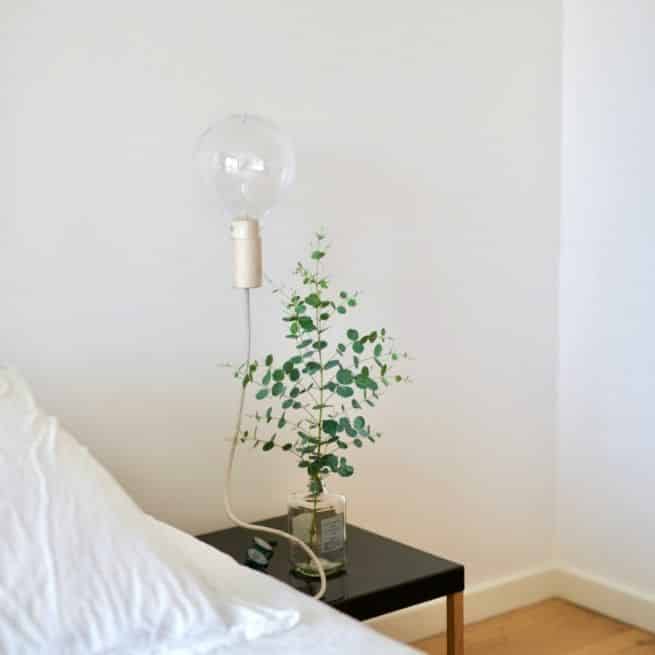 a picture of a greener home bedside table with lamp