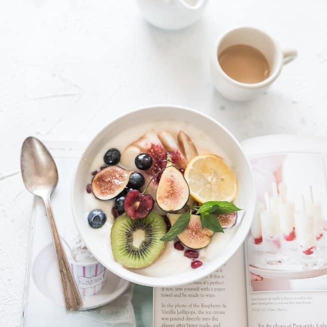 Colorful bowl of fruit as as example of a healthy breakfast on your self love checklist