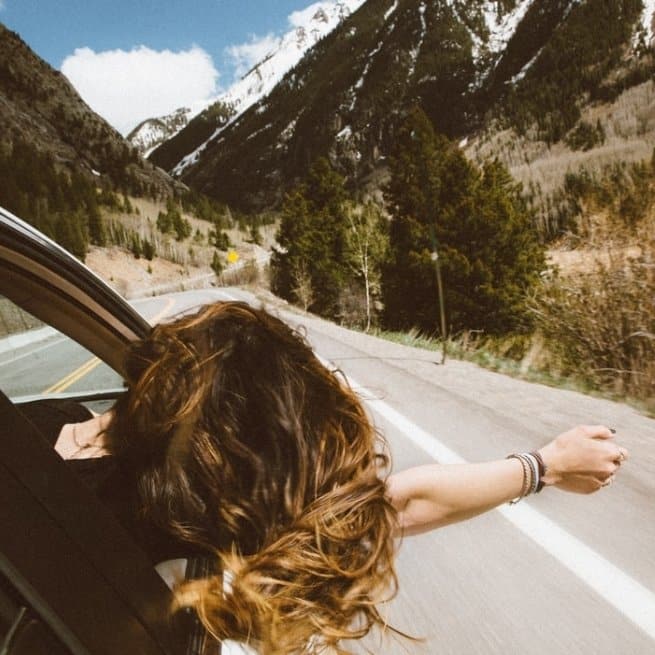 positive affirmations girl leaning out of a car