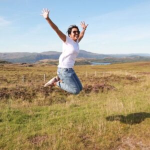 woman jumping in field